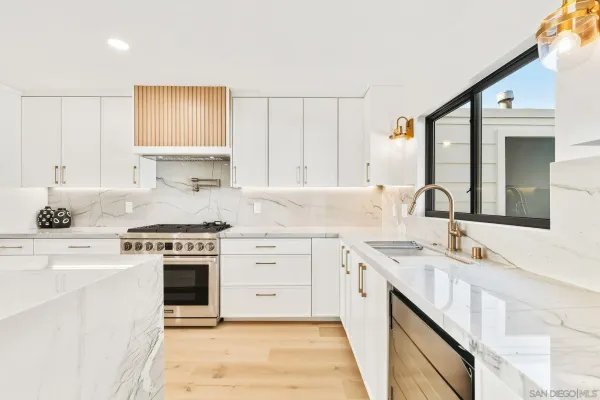 a kitchen with kitchen island a refrigerator and a stove