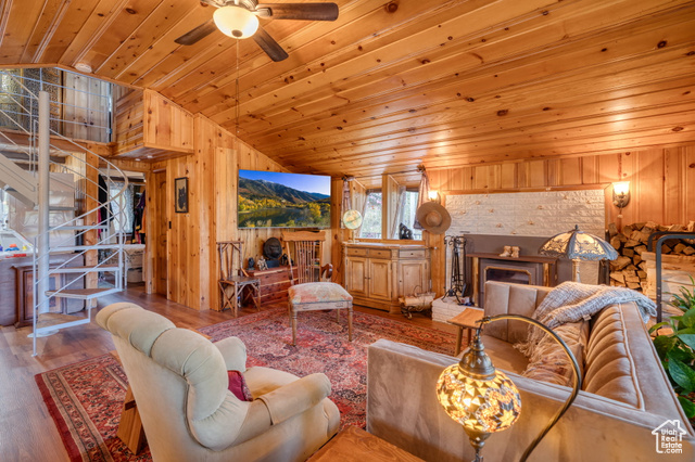 714 Spotted Fawn Way Kamas, UT 84036 - Photo 5 of 34 Living area with wood walls, wood finished floors, wood ceiling, vaulted ceiling, and a ceiling fan