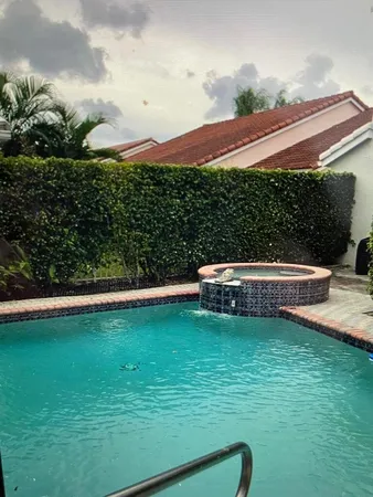 a view of a swimming pool with a garden