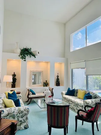 a living room with furniture and a potted plant