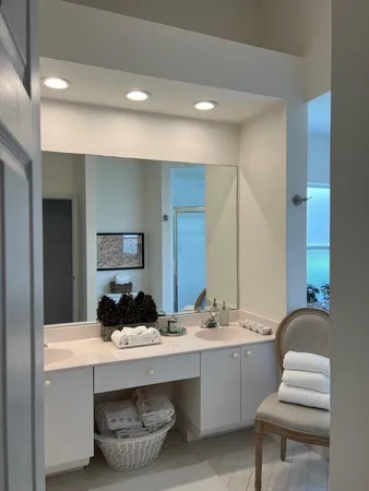 a bathroom with a double vanity sink and a mirror