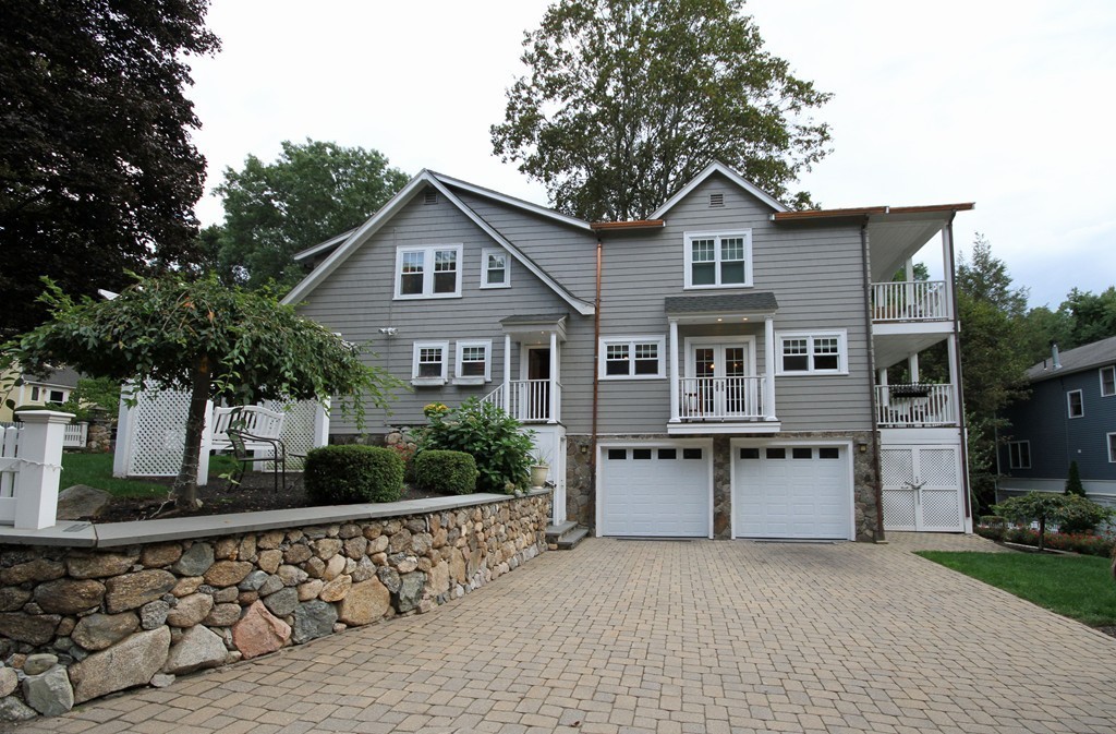1 Stevens Road Wellesley, MA 02482 - Photo 2 of 18 a front view of a house with a yard and garage