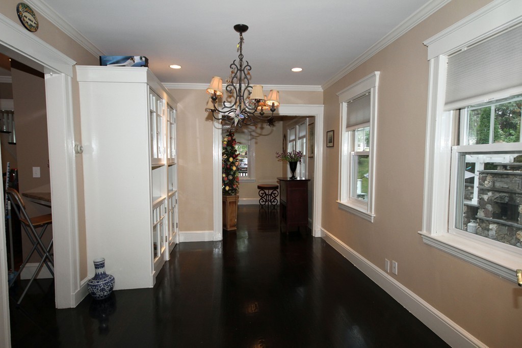 1 Stevens Road Wellesley, MA 02482 - Photo 6 of 18 a view of a hallway with windows and chandelier