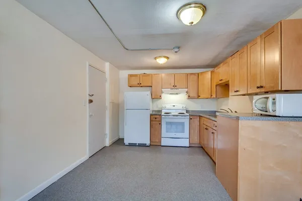 a kitchen with stainless steel appliances granite countertop a refrigerator sink and cabinets