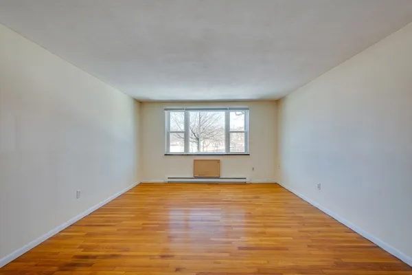 a bedroom with a bed lamp and a window
