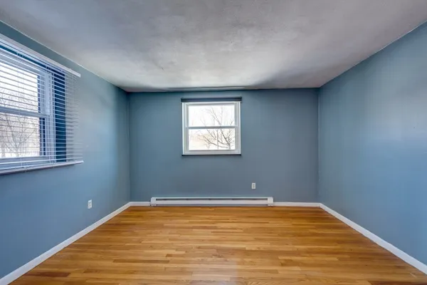a view of a room with wooden floor and windows