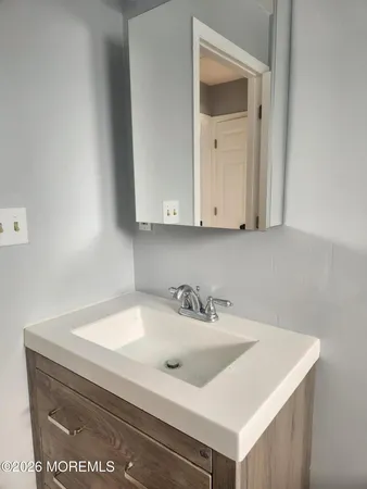 a kitchen with a sink cabinets and a window