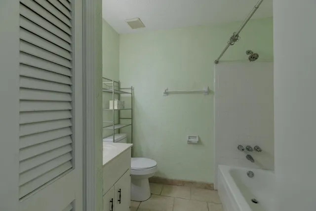 a bathroom with a toilet and shower