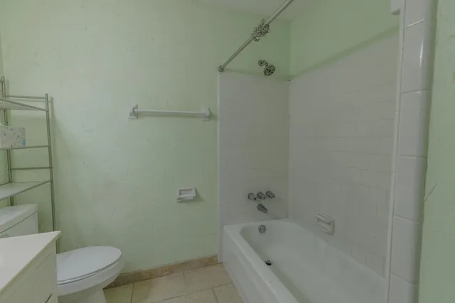 a bathroom with a bathtub and toilet