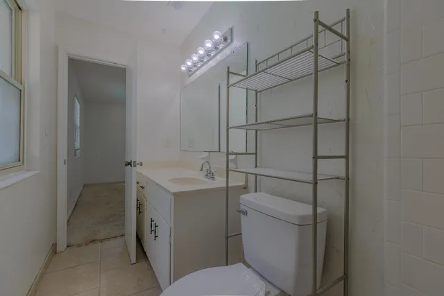 a bathroom with a toilet sink and shower