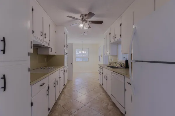 a kitchen with granite countertop a sink and a stove top oven