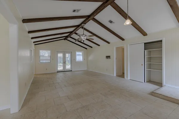 a view of a big room with closet and windows