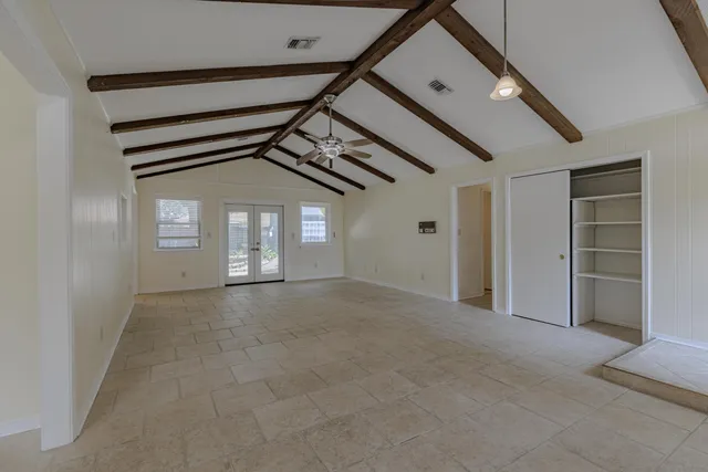a view of a big room with closet and windows