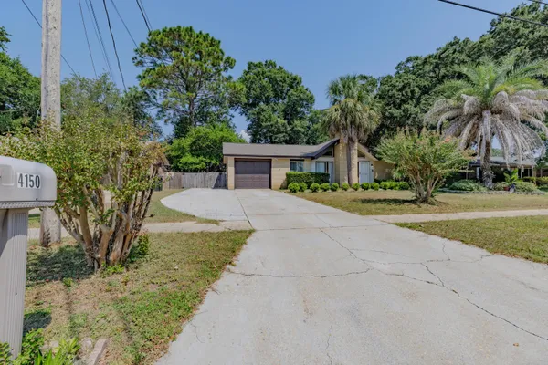 a view of house with outdoor space and trees around