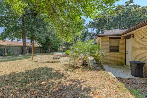 a view of backyard of house with green space