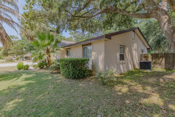a house that has a tree in front of the house