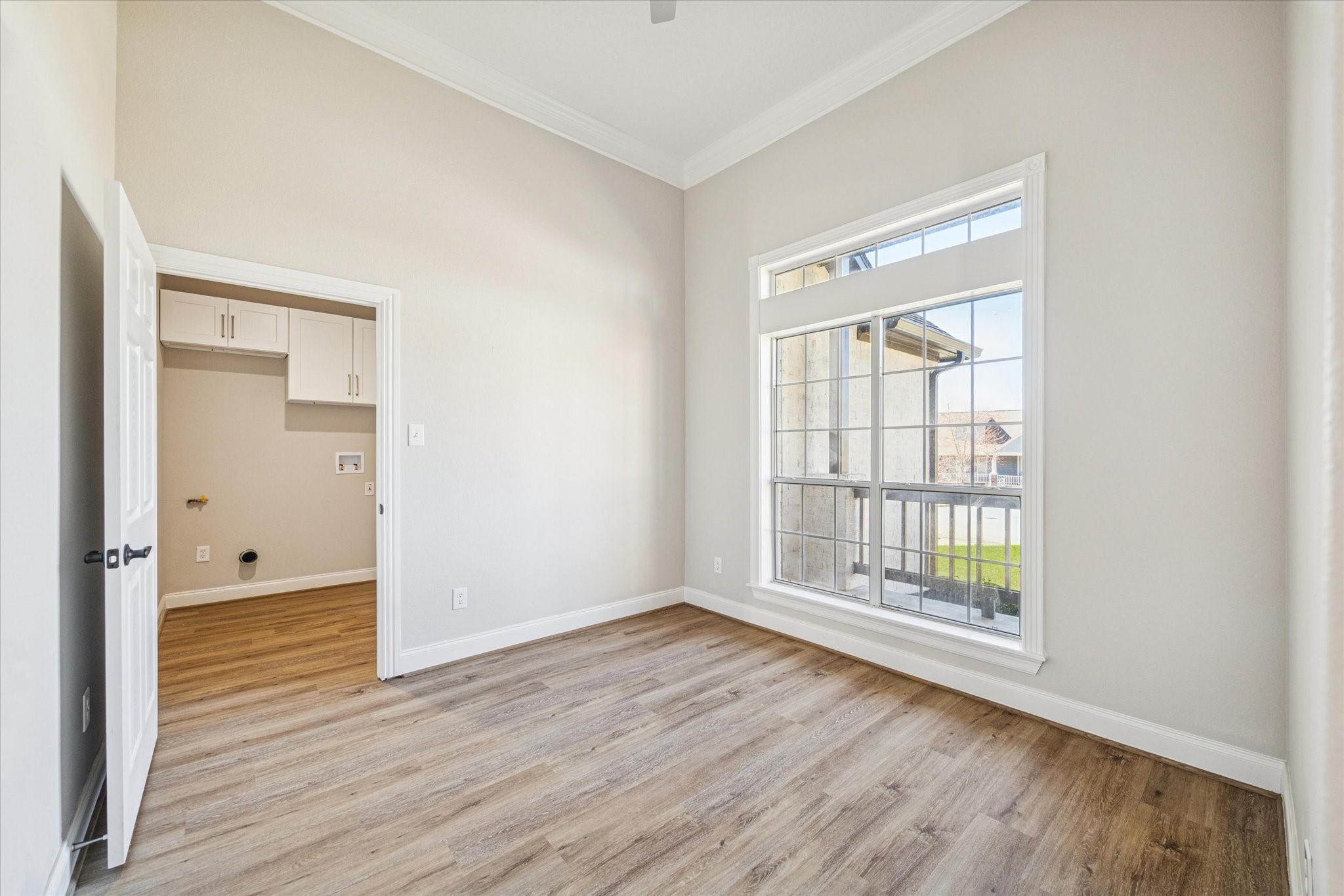 5437 Edgewater Court Willis, TX 77318 - Photo 19 of 29 an empty room with wooden floor and windows