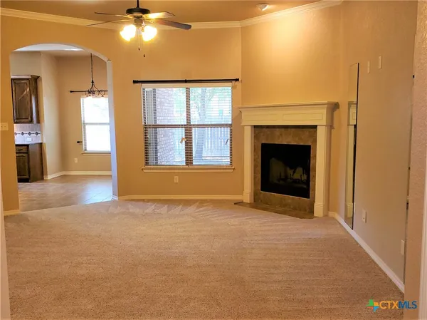 a view of an empty room with a fireplace