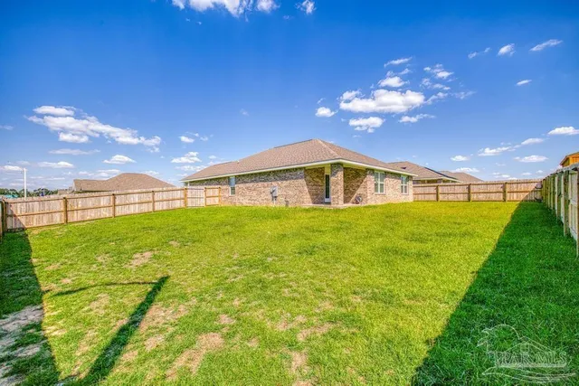 a very nice looking yard with a house