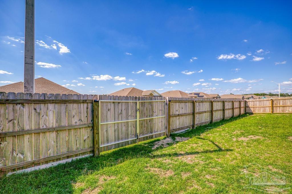 9336 Tara Circle Milton, FL 32583 - Photo 14 of 45 a view of a backyard with wooden fence