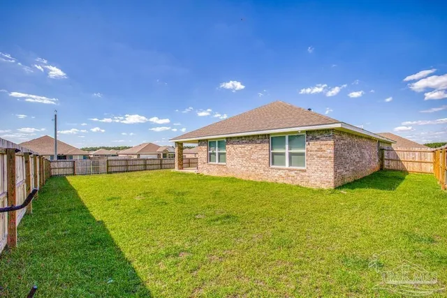 a view of a house with a backyard