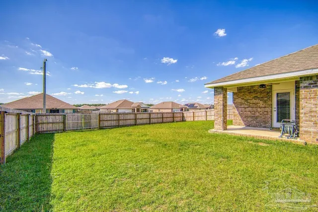 a view of a house with backyard and porch