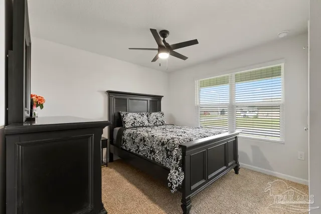 a bedroom that has a bed and a window