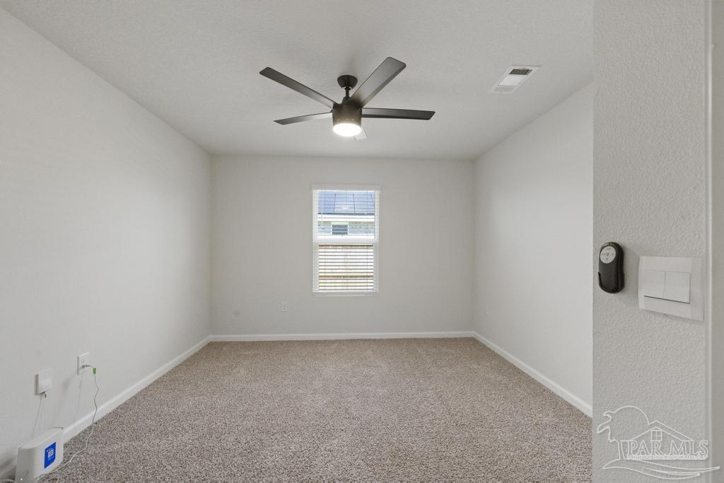 9336 Tara Circle Milton, FL 32583 - Photo 29 of 45 an empty room with a window and a fan