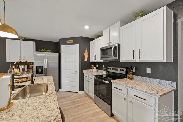 a kitchen with a sink stove and refrigerator