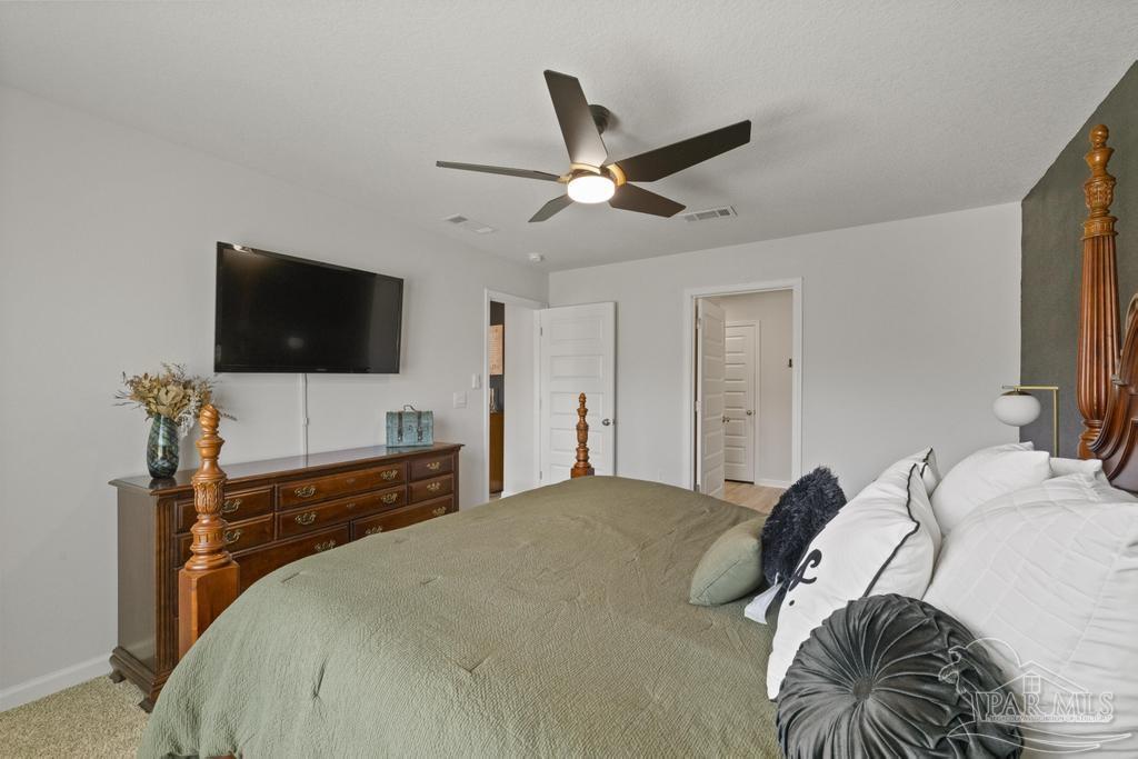 9336 Tara Circle Milton, FL 32583 - Photo 42 of 45 a bedroom with a bed and a flat screen tv