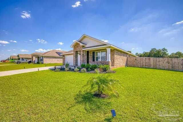 a front view of house with yard and swimming pool