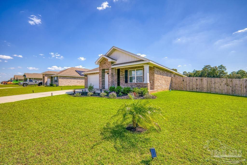 9336 Tara Circle Milton, FL 32583 - Photo 6 of 45 a front view of house with yard and swimming pool