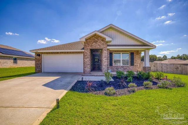 a front view of a house with a garden and plants