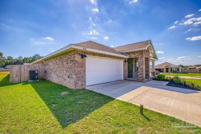 a view of a house with a yard and garage