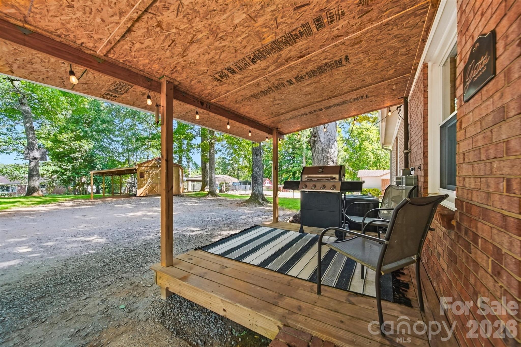 1312 County Home Road Conover, NC 28613 - Photo 23 of 25 a view of a patio with table and chairs next to a yard