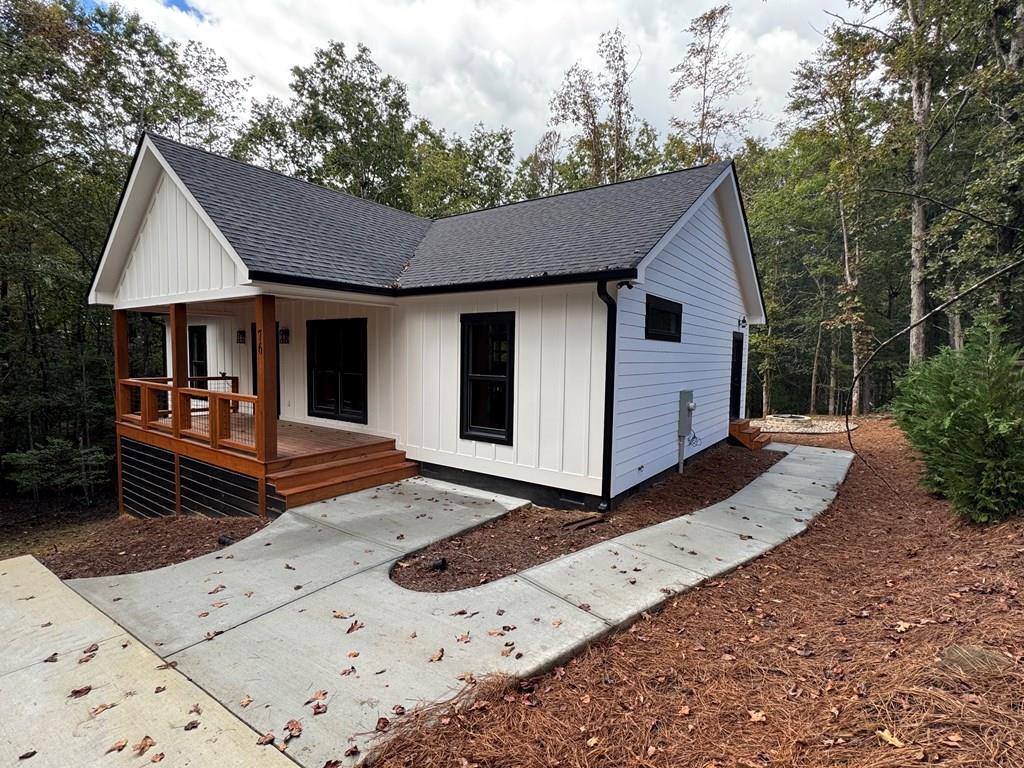 76 Cypress Circle Ellijay, GA 30540 - Photo 1 of 35 a front view of a house with garden