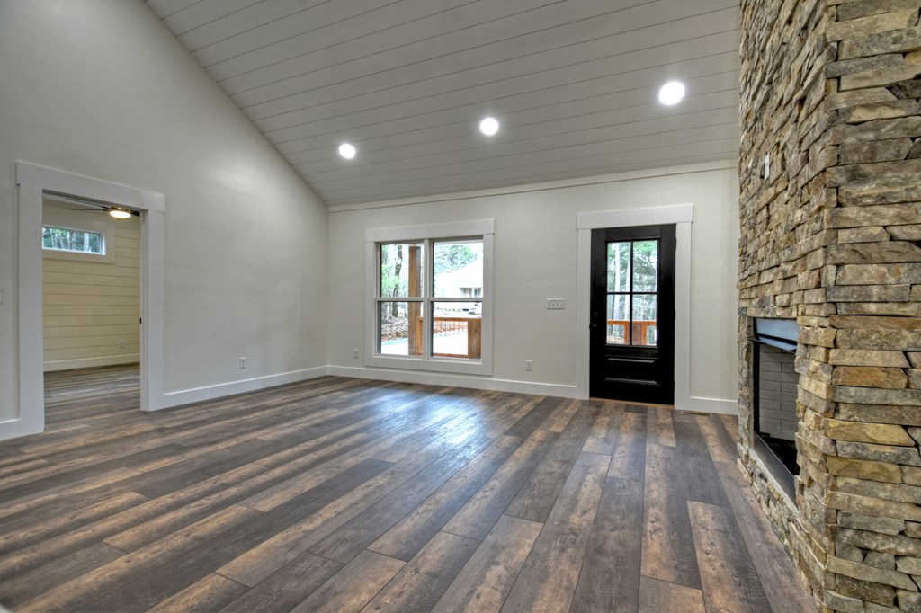76 Cypress Circle Ellijay, GA 30540 - Photo 11 of 35 wooden floor in an empty room with a fireplace