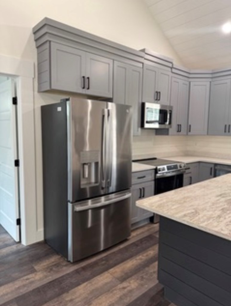 76 Cypress Circle Ellijay, GA 30540 - Photo 16 of 35 a kitchen with granite countertop a refrigerator stove and microwave