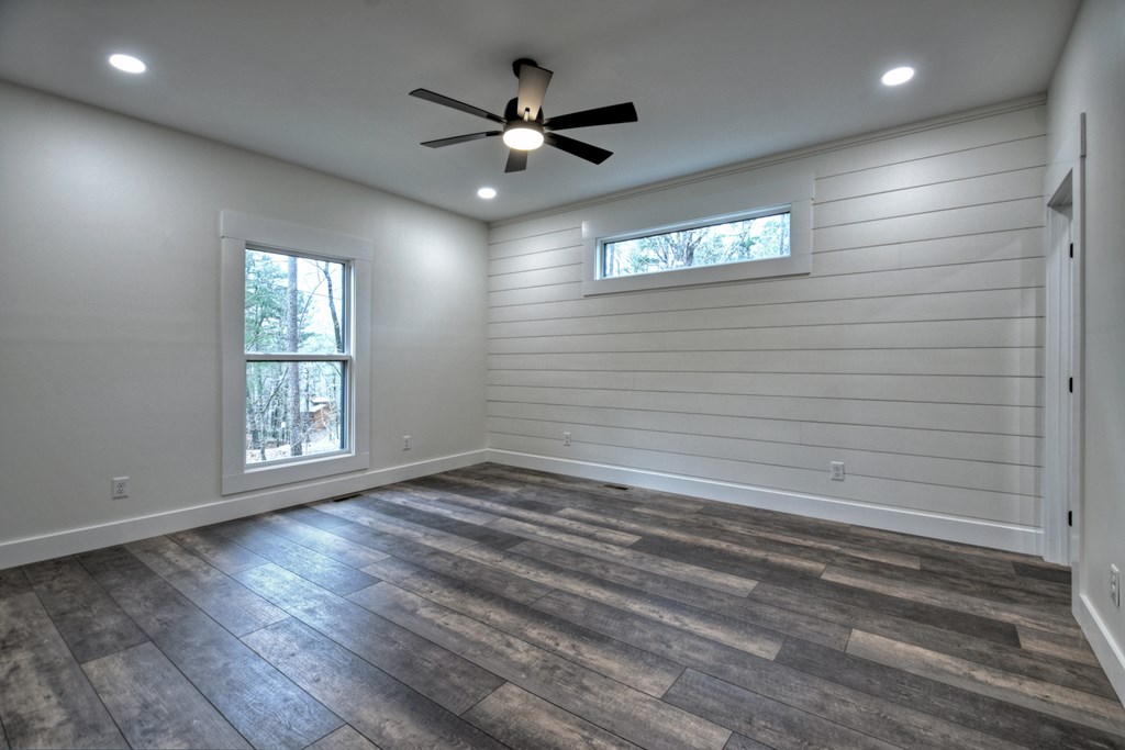 76 Cypress Circle Ellijay, GA 30540 - Photo 25 of 35 an empty room with wooden floor and windows
