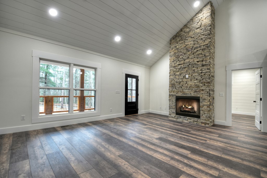 76 Cypress Circle Ellijay, GA 30540 - Photo 9 of 35 wooden floor in an empty room with a fireplace