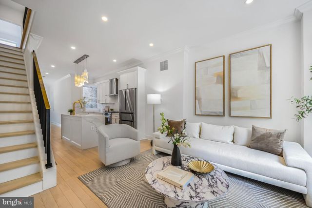 a living room with furniture or couch and a large window