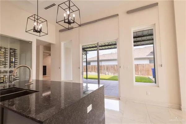 a kitchen with kitchen island stainless steel appliances granite countertop a sink and a stove