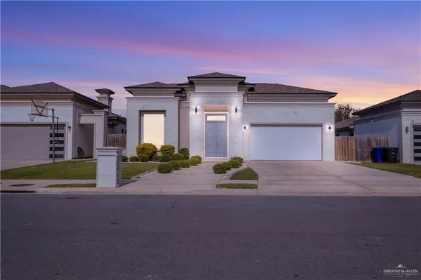 a front view of a house with a yard and a garage