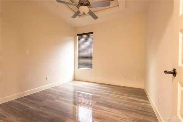 a bathroom with a granite countertop sink a toilet a mirror and shower