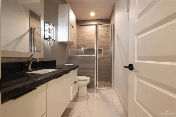 a bathroom with a toilet a sink and a mirror