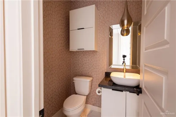 a bathroom with a toilet sink and mirror