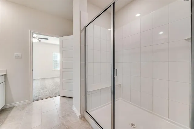 a bathroom with a shower and a glass door