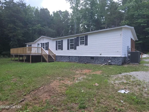 a front view of a house with a garden and yard