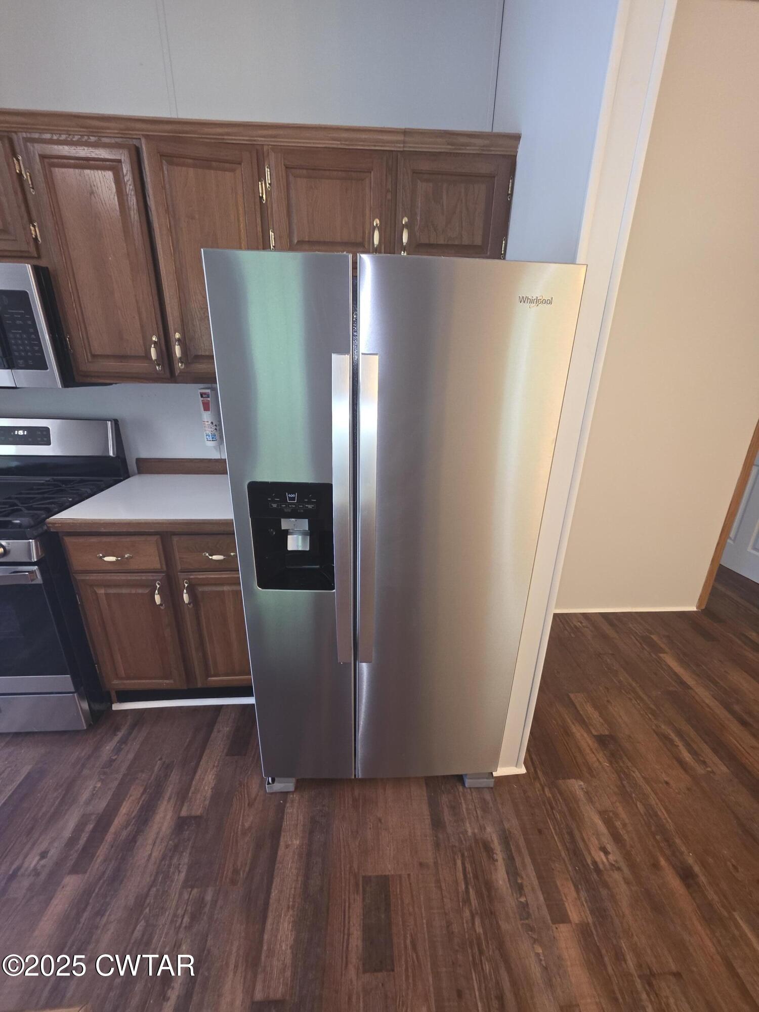 455 Liberty Road Beech Bluff, TN 38313 - Photo 11 of 63 a kitchen with a refrigerator and wooden floor