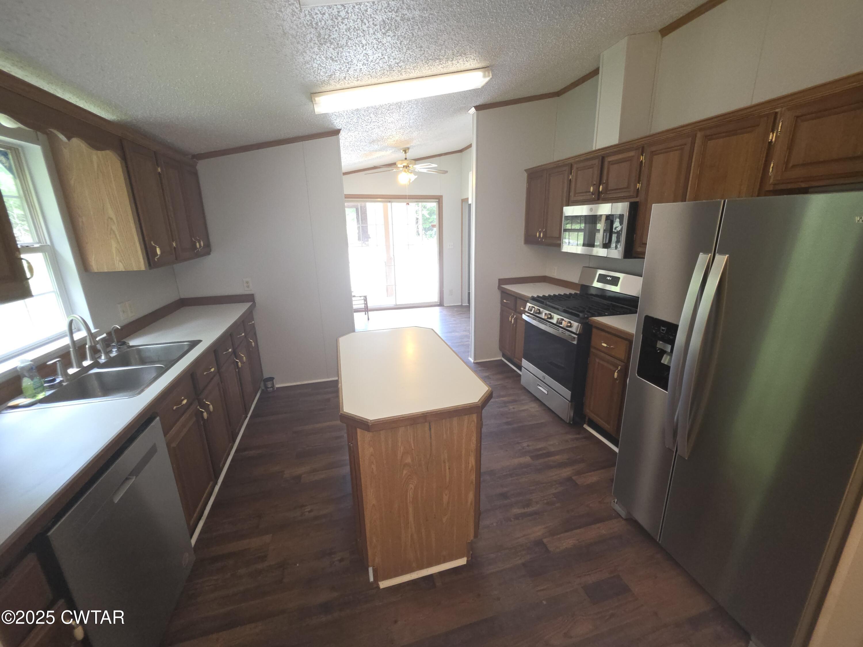 455 Liberty Road Beech Bluff, TN 38313 - Photo 13 of 63 a kitchen with stainless steel appliances a stove a refrigerator a sink a oven with wooden floor